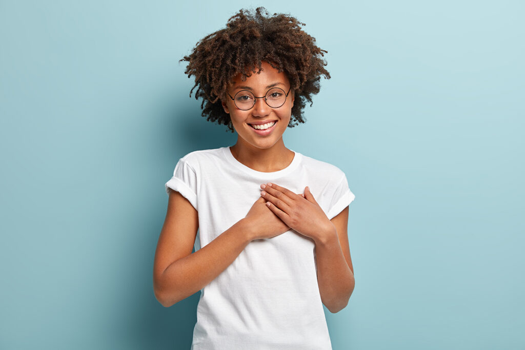 Happy woman holding heart.
